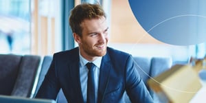 Man in suit smiling away from camera 