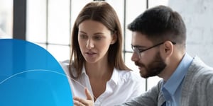 Woman explaining something to man next to her