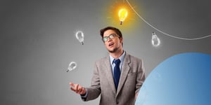man in suit juggling light bulbs looking up at one yellow light bulb 