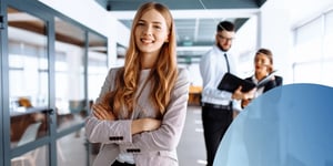Business woman standing in office with arms crossed and smiling